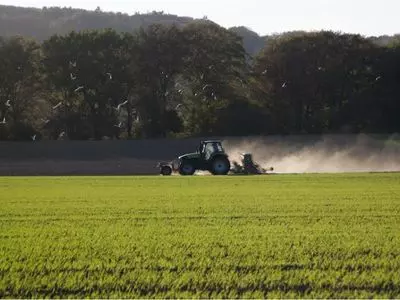 Tractor tilling a field