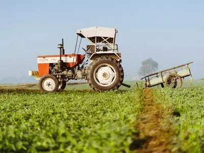 Tractor riding through a field